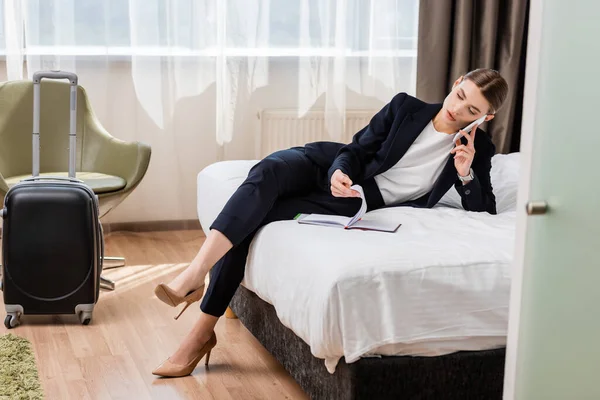 Businesswoman Suit Talking Smartphone Looking Notebook Hotel Room — Stock Photo, Image