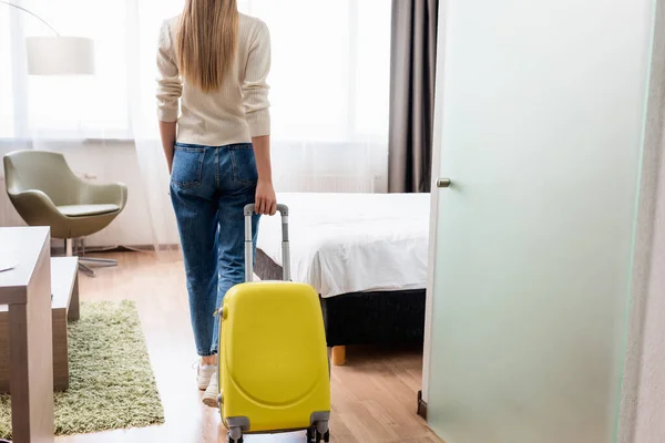 Back View Woman Jeans Standing Yellow Luggage Hotel Room — Stock Photo, Image