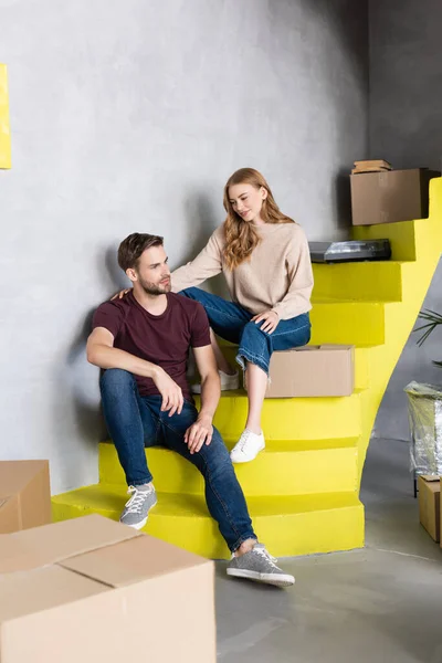 Woman Touching Boyfriend While Sitting Stairs Boxes — Stock Photo, Image