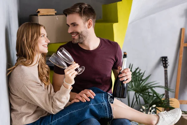 Joyful Couple Holding Bottle Champagne Glasses While Looking Each Other — Stock Photo, Image