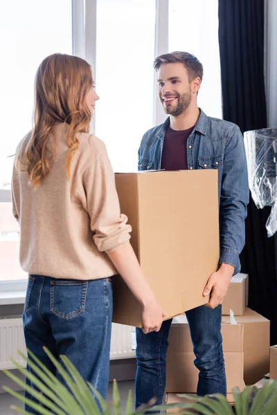 Joyful Man Looking Woman While Holding Carton Box Together Moving — Stock Photo, Image