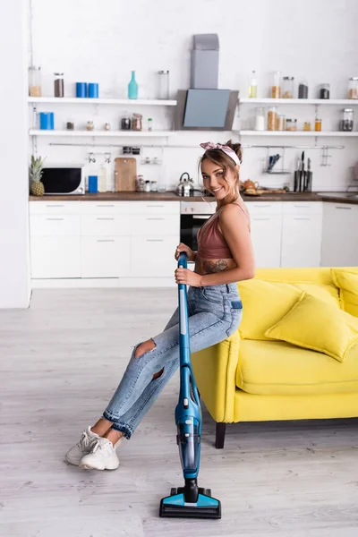 Housewife Sitting Yellow Couch Holding Modern Vacuum Cleaner Home — Stock Photo, Image