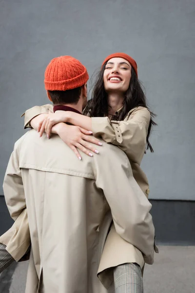 Back View Man Holding Arms Joyful Woman Beanie Hat Trench — Stock Photo, Image