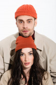 man in beanie hat and stylish young woman looking at camera isolated on white