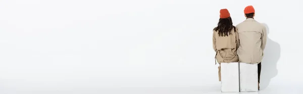 Website Header Trendy Couple Beanie Hats Trench Coats Sitting White — Stock Photo, Image