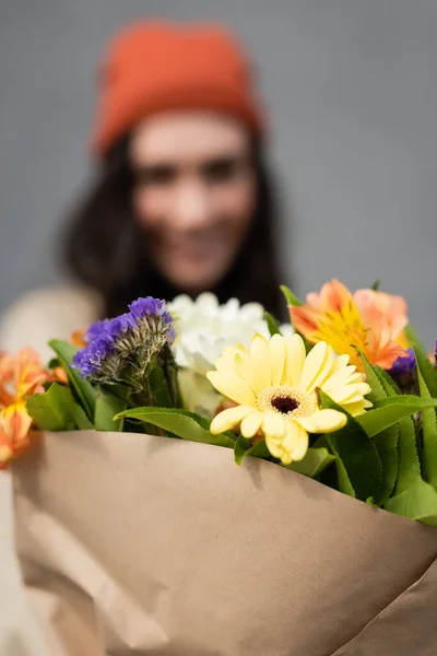 Selective focus of bouquet with flowers near woman — Stock Image Selective Focus Bouquet Flowers Woman Royalty Free Stock Images