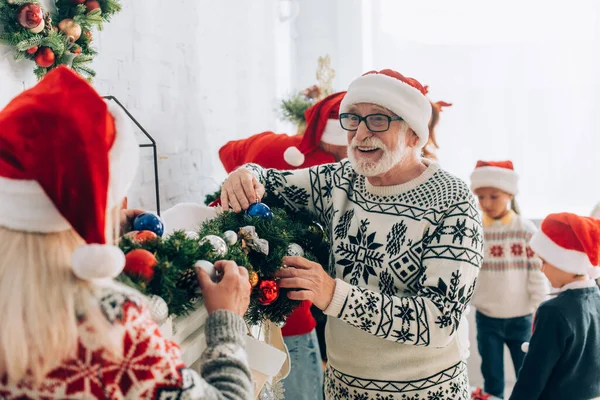 Happy Senior Man Santa Hat Eyeglasses Decorating Spruce Branch Together — Stock Photo, Image