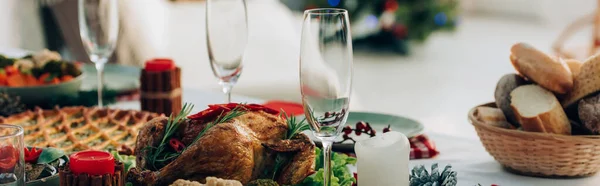 Website header of served table with baked turkey, pie and wineglasses