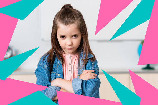 Serious schoolgirl with crossed arms looking at camera near colorful triangles illustration 
