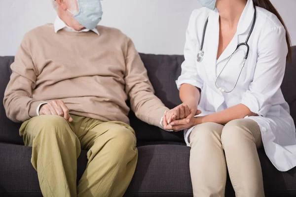 Partial View Social Worker Medical Mask Holding Hands Aged Man — Stock Photo, Image