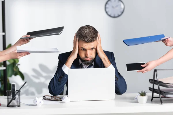 Exhausted Businessman Touching Head Colleagues Paper Folders Smartphone Office — Stock Photo, Image