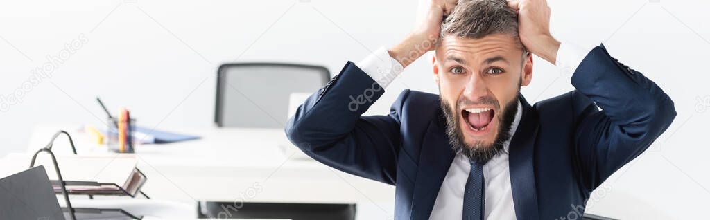 Screaming businessman looking at camera in office, banner 