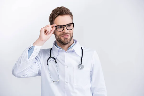 Smiling Doctor Stethoscope Holding Eyeglasses Frame While Looking Away Isolated — Stock Photo, Image