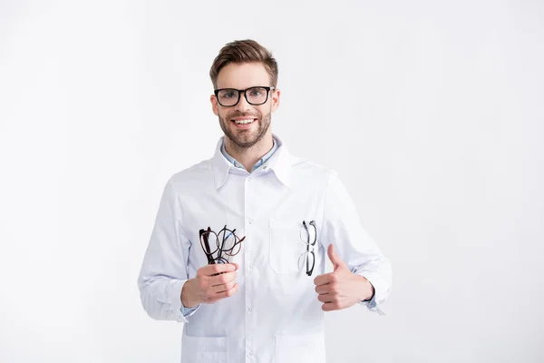 Front View Smiling Doctor Thumb Holding Several Eyeglasses While Looking — Stock Photo, Image
