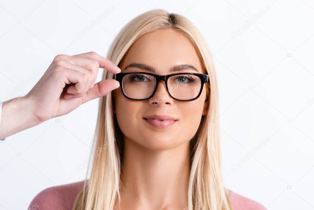 Ophthalmologist holding eyeglasses frame of blonde woman isolated on white