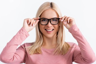 Blonde woman looking at camera while wearing eyeglasses isolated on white clipart