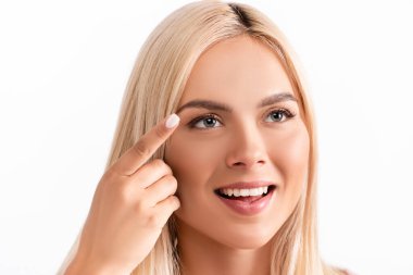 Positive blonde woman holding contact lens isolated on white clipart