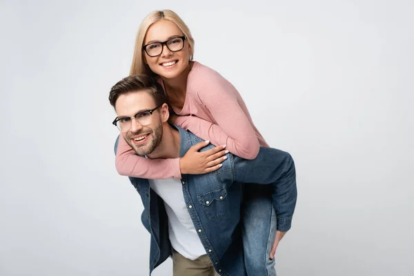 Smiling Woman Eyeglasses Piggybacking Boyfriend Isolated Grey — Stock Photo, Image