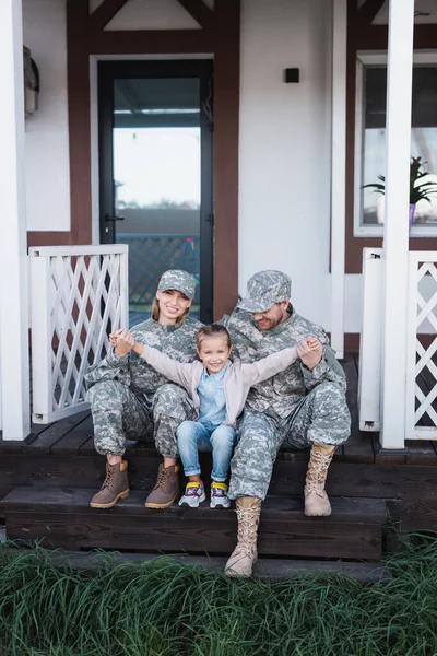 Happy Daughter Outstretched Hands Sitting Mother Father Military Uniforms Wooden — Stock Photo, Image