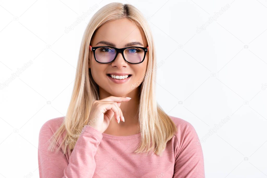 Smiling woman in eyeglasses with hand near chin looking at camera isolated on white