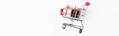 Horizontal image of toy gift boxes and shopping cart on white background clipart