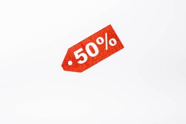 Top view of red price tag with fifty percent signs on white background clipart