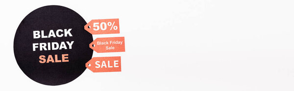 Website header of price tags and black circle with black friday sale lettering on white background