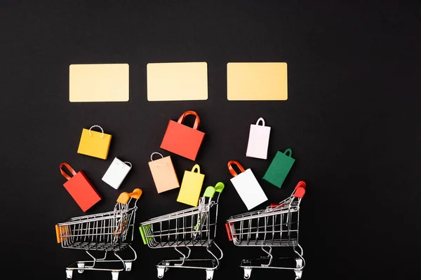 Top View Credit Cards Toy Shopping Bags Carts Black Background — Stock Photo, Image