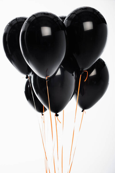Decorative black balloons on strings isolated on white 