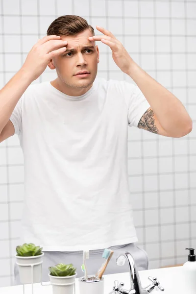 Worried Young Adult Man Touching Wrinkles Forehead Bathroom — Stock Photo, Image