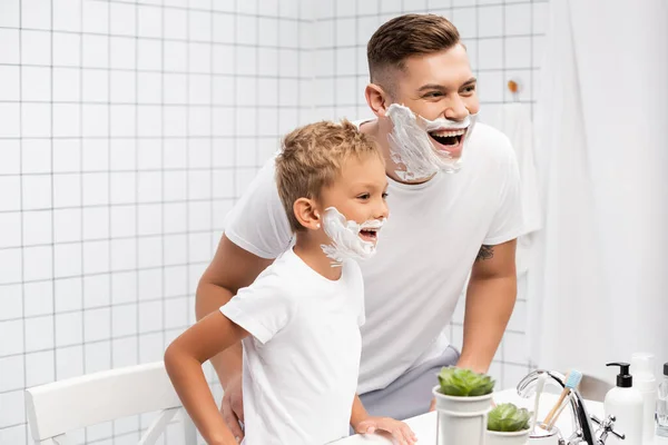 화장실에서 세면기로 세면대를 의지하고 아버지 와아들은 얼굴에 거품을 묻히고 — 스톡 사진