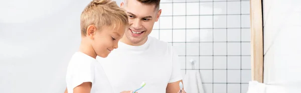 Smiling Father Looking Son Holding Toothbrush Bathroom Banner — Stock Photo, Image