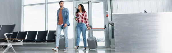 Happy Multicultural Couple Walking Luggage Passports Airport Banner — Stock Photo, Image