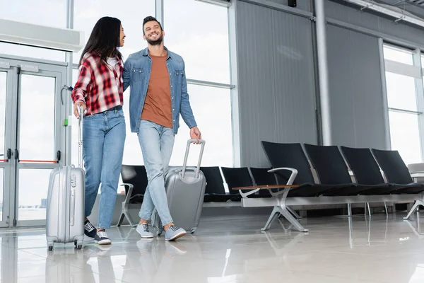 Cheerful Multicultural Couple Walking Luggage Airport — Stock Photo, Image