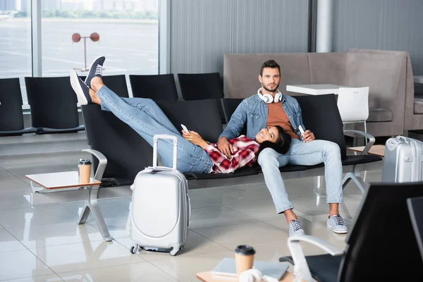 Happy African American Woman Holding Phone Lying Bearded Man Sitting — Stock Photo, Image