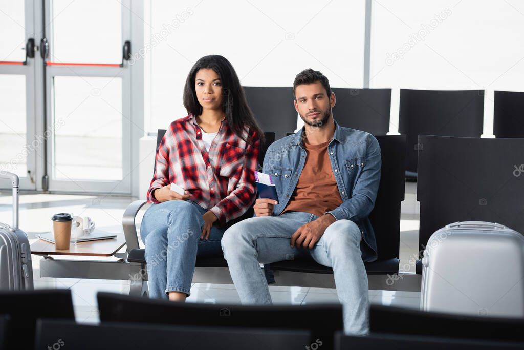 interracial passengers holding passports with air tickets in airport