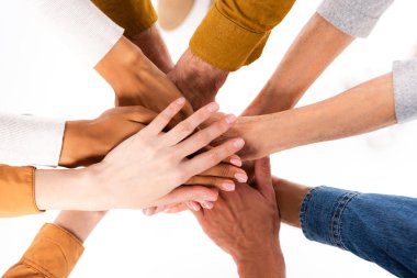 Top view of multiethnic people holding hands isolated on white clipart