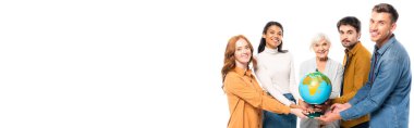 Multicultural people smiling at camera while holding globe together isolated on white, banner 