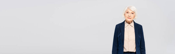Grey haired woman looking at camera isolated on grey, banner 