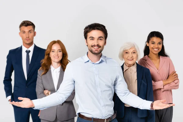 Fröhlicher Geschäftsmann Zeigt Mit Den Händen Auf Multiethnische Kollegen Die — Stockfoto