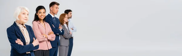 African American Businesswoman Smiling Camera Colleagues Crossed Arms Blurred Background — Foto de Stock