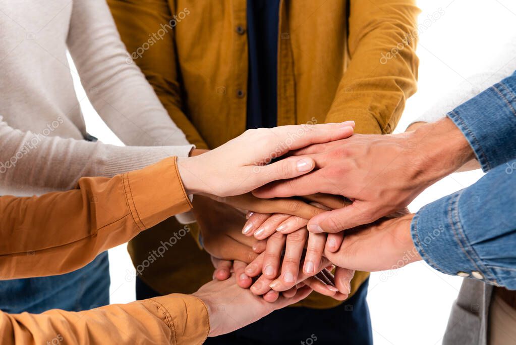 Cropped view of multicultural people holding hands isolated on white