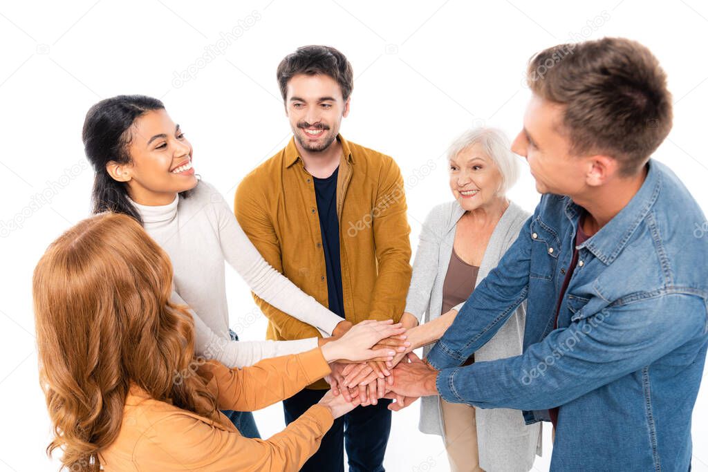 Smiling multicultural people holding hands isolated on white