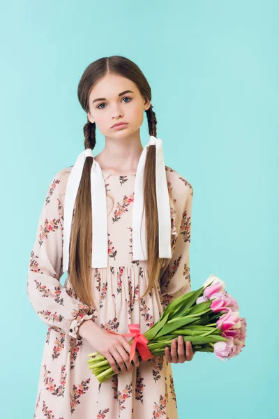 Hermosa chica con trenzas en vestido de verano con tulipanes, aislado en azul - foto de stock