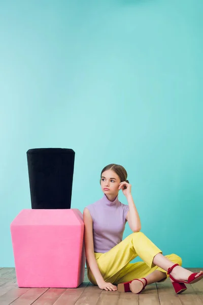 Teen girl with big nail polish sitting on floor — Stock Photo