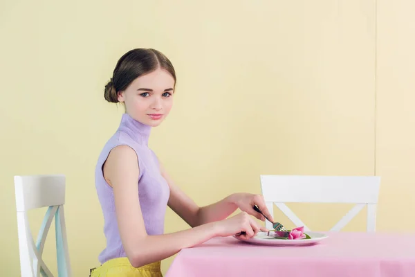 Beautiful teen girl eating tulip, diet concept — Stock Photo