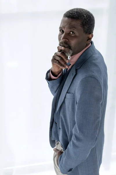 Thoughtful african american man in blue jacket — Stock Photo