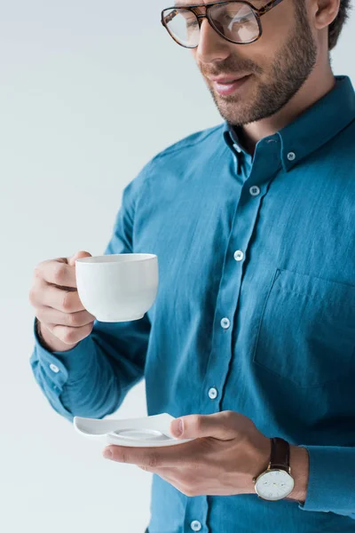 Счастливый молодой человек с чашкой кофе изолированы на белом — стоковое фото