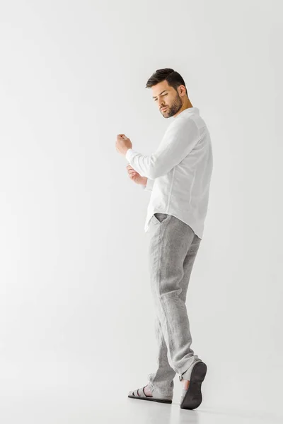 Low angle view of man in linen white shirt looking away isolated on grey background — Stock Photo