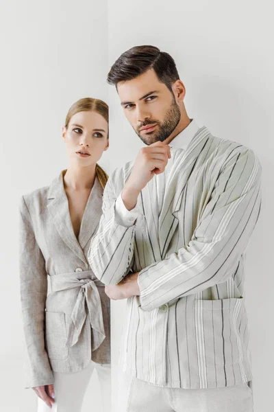 Attractive young male and female models in vintage jackets on white — Stock Photo